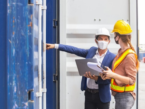 Occupational Health Specialist - two people in hard hats talking about the safety of a workplace