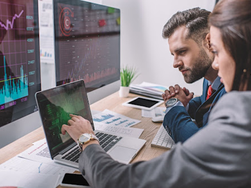 Operations Research Analyst - two analysts looking at graphs on a computer