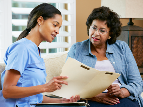 Public Health Advisor - a doctor in scrubs talking to a woman