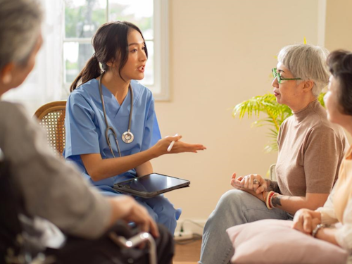 Public Health Nurse - a nurse in scrubs talking to a group of people